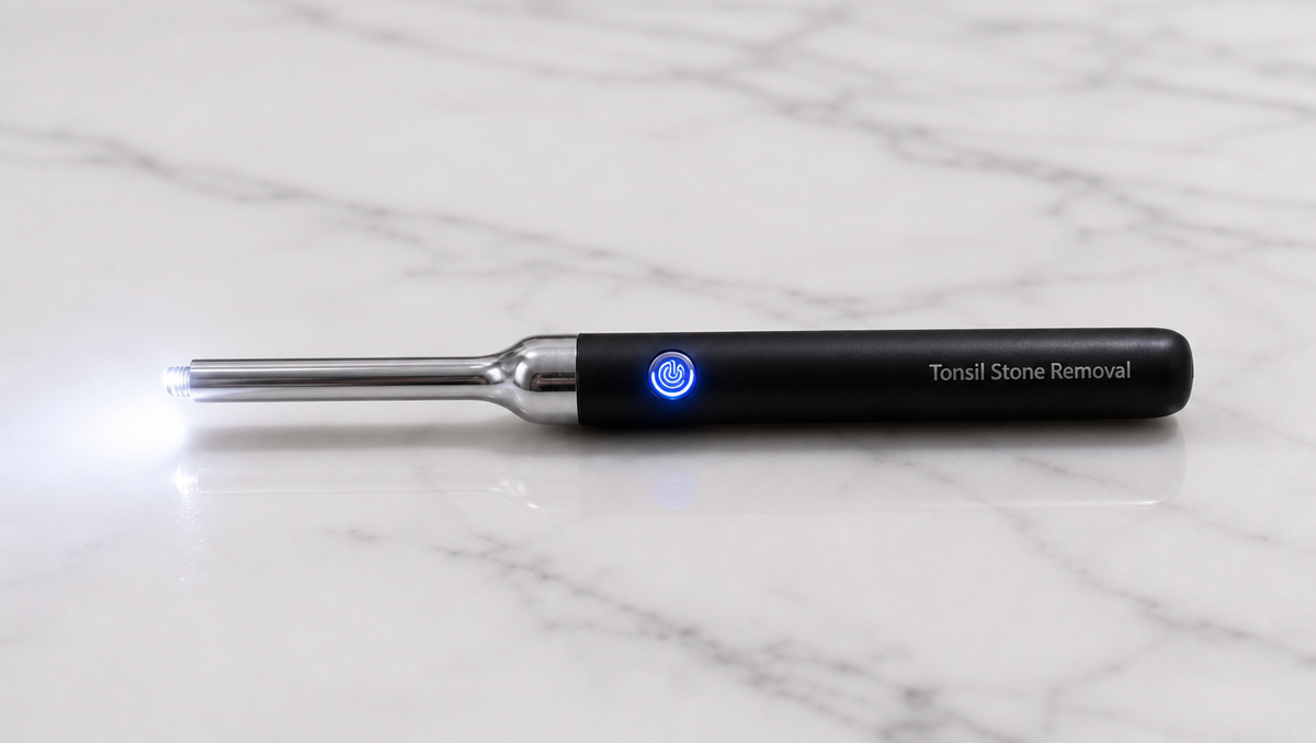 TonsiCare Pro lying on a table with its six LED lights switched on, illuminating the tip